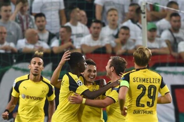 Dortmund's Raphael Guerreiro, center, celebrates with his teammates after scoring goal during the Champions League Group F soccer match between Legia Warsaw and Dortmund at Stadion Wojska Polskiego in Warsaw, Poland, Wednesday, Sept. 14, 2016. (AP Photo/Alik Keplicz)