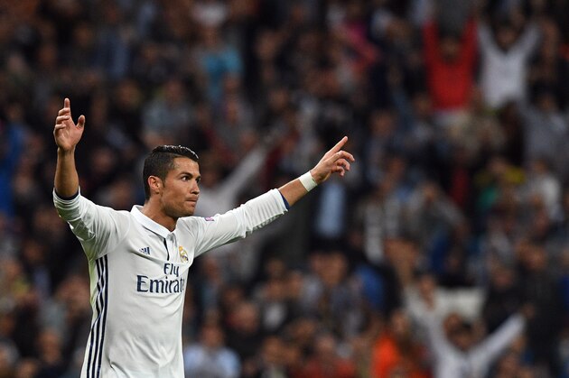 Real Madrid's Portuguese forward Cristiano Ronaldo celebrates after scoring the equalizer during the UEFA Champions League football match Real Madrid CF vs Sporting CP at the Santiago Bernabeu stadium in Madrid on September 14, 2016. / AFP / GERARD JULIEN        (Photo credit should read GERARD JULIEN/AFP/Getty Images)