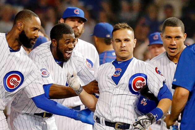 CHICAGO, IL - AUGUST 29: (L-R) Jason Heyward #22 of the Chicago Cubs and Dexter Fowler #24 celebrate the walkoff RBI single by Miguel Montero #47 in their win over the Pittsburgh Pirates at Wrigley Field on August 29, 2016 in Chicago, Illinois. The Chicago Cubs won 8-7 in thirteen innings.  (Photo by Jon Durr/Getty Images)