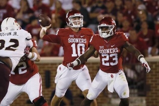 Oklahoma quarterback Austin Kendall (10) throws behind running back Abdul Adams (23) during an NCAA college football game between Louisiana Monroe and Oklahoma in Norman, Okla., Saturday, Sept. 10, 2016. (AP Photo/Sue Ogrocki)
