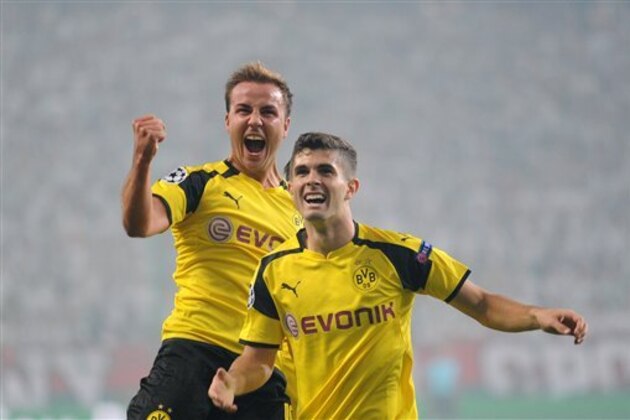 Dortmund's Mario Goetze, left, celebrates with Christian Pulisic after scoring the first goal of his team during the Champions League Group F soccer match between Legia Warsaw and Dortmund at Stadion Wojska Polskiego in Warsaw, Poland, Wednesday, Sept. 14, 2016. (AP Photo/Alik Keplicz)