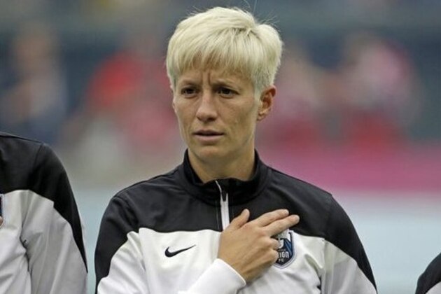 Seattle Reign forward Megan Rapinoe is shown during the national anthem before an NWSL soccer match against the Portland Thorns in Portland, Ore., Wednesday, July 22, 2015. (AP Photo/Don Ryan)