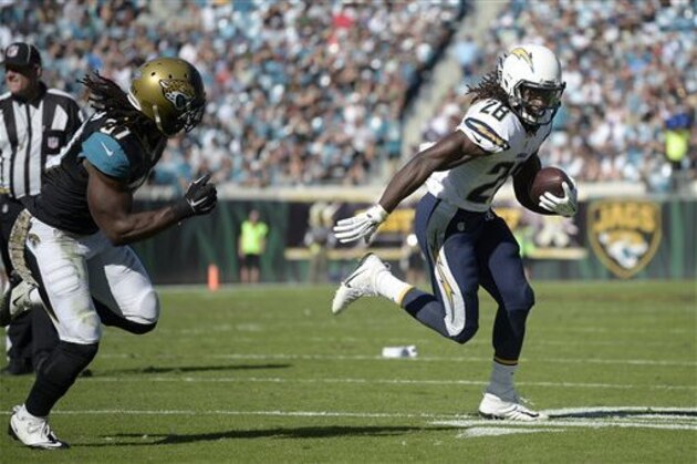 San Diego Chargers running back Melvin Gordon (28) rushes for yardage in front of Jacksonville Jaguars strong safety Johnathan Cyprien (37) during the first half of an NFL football game in Jacksonville, Fla., Sunday, Nov. 29, 2015. (AP Photo/Phelan M. Ebenhack)