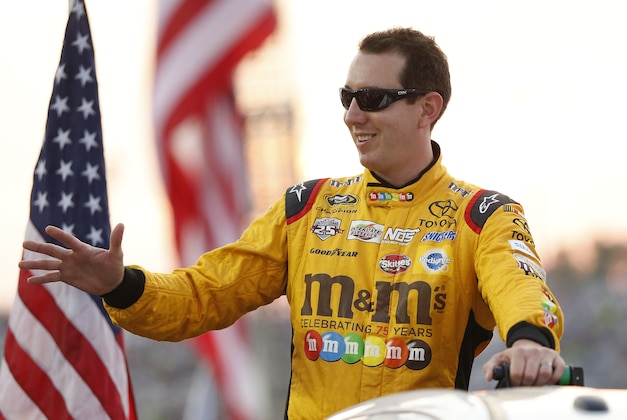 Sep 10, 2016; Richmond, VA, USA; Sprint Cup Series driver Kyle Busch (18) waves to the fans during driver introductions prior to during the Federated Auto Parts 400 at Richmond International Raceway. Mandatory Credit: Amber Searls-USA TODAY Sports