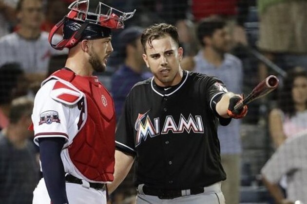 Miami Marlins' Jose Fernandez, right, talks with Atlanta Braves catcher Tyler Flowers after Atlanta reliever Jose Ramirez threw inside to Fernandez in the seventh inning of a baseball game in Atlanta, Wednesday, Sept. 14, 2016. The benches for both teams emptied in the seventh inning after the pitch to Fernandez, who had been knocked to the ground by a pitch from Teheran in the fifth. No punches were thrown and Ramirez was ejected. (AP Photo/David Goldman)