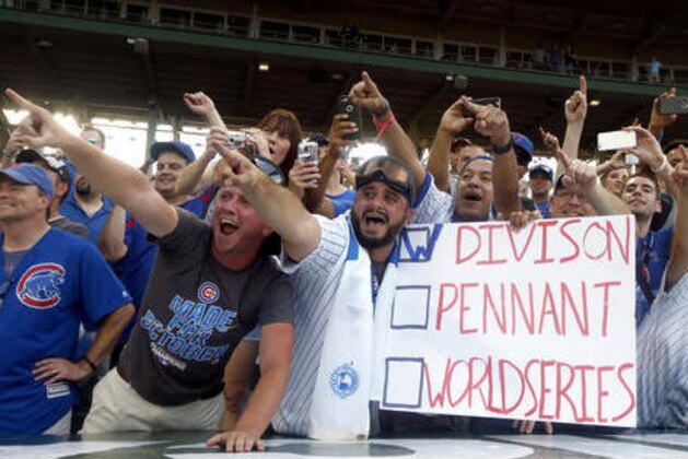 Chicago Cubs fans celebrate the team's NL Central title, Friday, Sept. 16, in Chicago, after the Cubs defeated the Milwaukee Brewers 5-4 in a baseball game. The Cubs won the title when the St. Louis Cardinals lost to the San Francisco Giants on Thursday night.  (AP Photo/Nam Y. Huh)