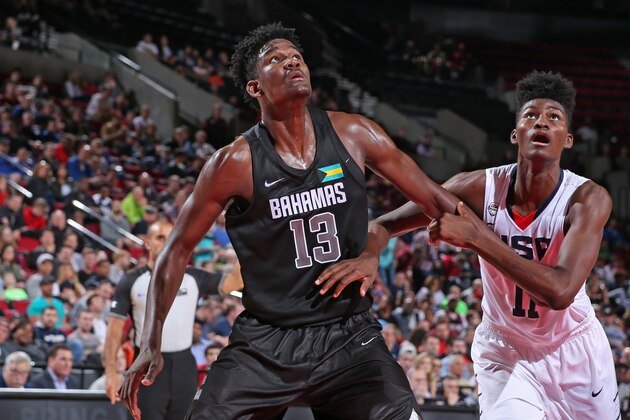 PORTLAND, OR - APRIL 9:  DeAndre Ayton #13 the World Select Team boxes out Jonathan Issac #11 of the USA Junior Select Team during the game on April 9, 2016 at the MODA Center Arena in Portland, Oregon. NOTE TO USER: User expressly acknowledges and agrees that, by downloading and or using this photograph, User is consenting to the terms and conditions of the Getty Images License Agreement. Mandatory Copyright Notice: Copyright 2016 NBAE (Photo by Sam Forencich/NBAE via Getty Images)