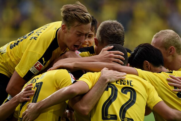 Dortmund's players celebrate during the German first division Bundesliga football match of Borussia Dortmund vs SV Darmstadt 98 in Dortmund, western Germany, on September 17, 2016. / AFP / PATRIK STOLLARZ / RESTRICTIONS: DURING MATCH TIME: DFL RULES TO LIMIT THE ONLINE USAGE TO 15 PICTURES PER MATCH AND FORBID IMAGE SEQUENCES TO SIMULATE VIDEO. == RESTRICTED TO EDITORIAL USE == FOR FURTHER QUERIES PLEASE CONTACT DFL DIRECTLY AT + 49 69 650050
        (Photo credit should read PATRIK STOLLARZ/AFP/Getty Images)