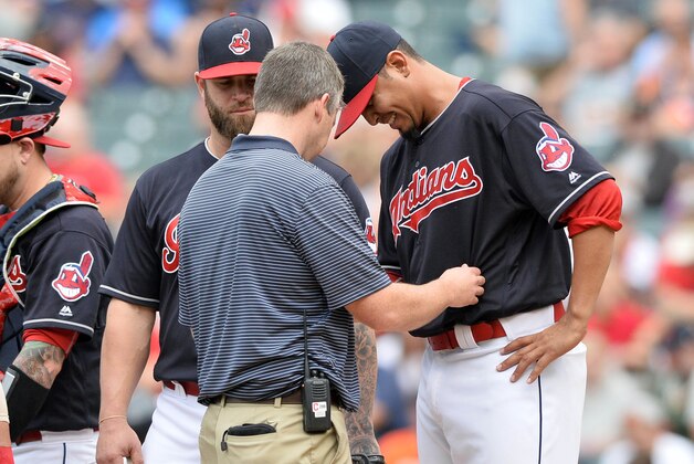 Sep 17, 2016; Cleveland, OH, USA; Cleveland Indians starting pitcher Carlos Carrasco (59) has his hand looked at by trainer James Quinlan after being hit by a batted ball during the first inning against the Detroit Tigers at Progressive Field. Carrasco left the game. Mandatory Credit: Ken Blaze-USA TODAY Sports