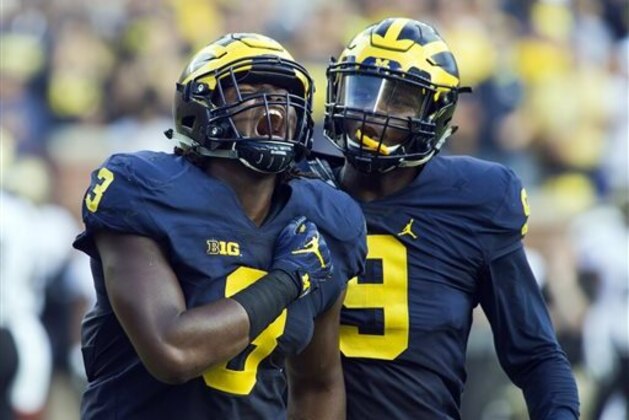 Michigan defensive end Rashan Gary (3) celebrates a sack alongside linebacker Mike McCray (9) in the first half of an NCAA college football game in Ann Arbor, Mich., Saturday, Sept. 17, 2016. (AP Photo/Tony Ding)