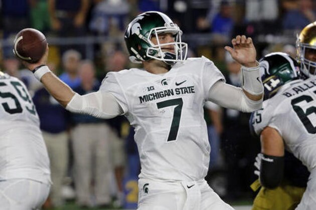 Michigan State quarterback Tyler O'Connor (7) throws against Notre Dame during the first half of an NCAA college football game Saturday, Sept. 17, 2016, in South Bend, Ind. (AP Photo/Charles Rex Arbogast)