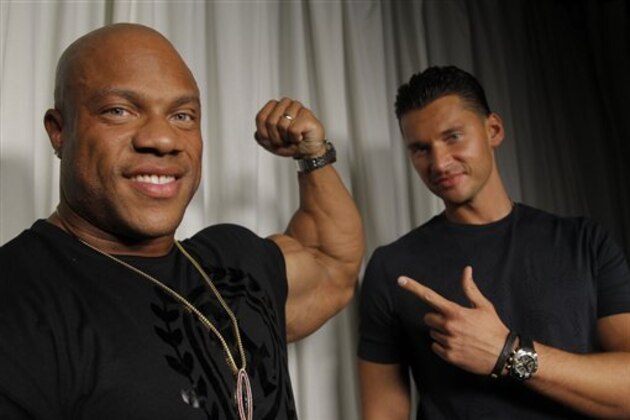 Director Vlad Yudin, right, and 2012 Mr. Olympia Phil Heath pose for a portrait Wednesday, September 18, 2013, in Los Angeles. Heath's quest for the Olympia title is the focal point of Yudin's bodybuilding documentary,