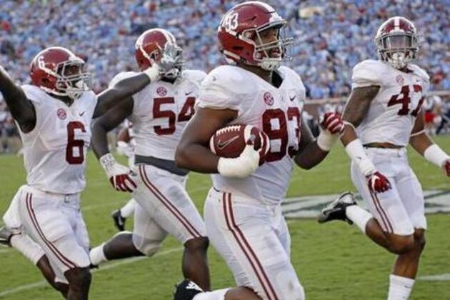 Alabama defensive lineman Jonathan Allen (93) is escorted into the end zone by teammates as he returns a 75-yard interception of a Mississippi pass in the second half of an NCAA college football game, Saturday, Sept. 17, 2016, in Oxford, Miss. (AP Photo/Rogelio V. Solis)