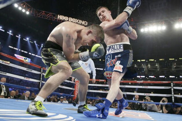 Canelo Alvarez punches Liam Smith during the eight round of the WBO Junior Middleweight championship boxing match at the stadium in Arlington, Texas, Saturday, Sept. 17, 2016. Alvarez won with a knock out in the ninth round. (AP Photo/LM Otero)
