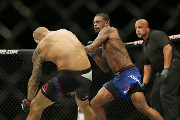 Sep 17, 2016; Hidalgo, TX, USA;  Dustin Poirier (red gloves) gets knocked down by Michael Johnson (blue gloves) during UFC Fight Night at State Farm Arena. Mandatory Credit: Sean Porkorny-USA TODAY Sports