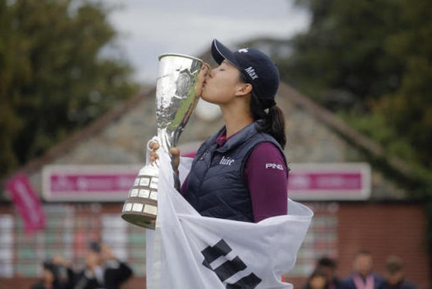 In Gee Chun of South Korea celebrates with her trophy after winning the Evian Championship women's golf tournament in Evian, eastern France, Sunday, Sept. 18, 2016. (AP Photo/Laurent Cipriani)