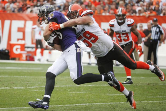 Baltimore Ravens tight end Dennis Pitta, left, is tackled by Cleveland Browns inside linebacker Tank Carder (59) in the second half of an NFL football game, Sunday, Sept. 18, 2016, in Cleveland. (AP Photo/Ron Schwane)
