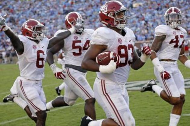 Alabama defensive lineman Jonathan Allen (93) is escorted into the end zone by his teammates as he returns a 75-yard interception of a Mississippi pass in the second half of an NCAA college football game, Saturday, Sept. 17, 2016 in Oxford, Miss. No. 1 Alabama won 48-43. (AP Photo/Rogelio V. Solis)
