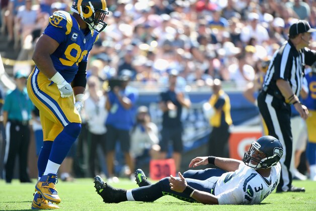 LOS ANGELES, CA - SEPTEMBER 18:  Quarterback Russell Wilson #3 of the Seattle Seahawks reacts after being sacked by Aaron Donald #99 of the Los Angeles Rams during the second quarter of the home opening NFL game between the Los Angeles Rams and the Seattle Seahawks at Los Angeles Coliseum on September 18, 2016 in Los Angeles, California.  (Photo by Harry How/Getty Images)