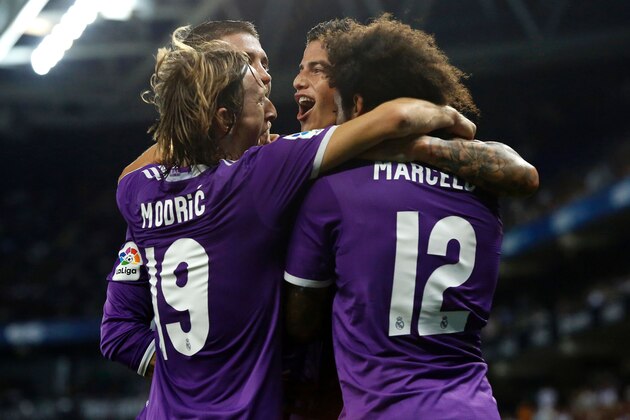 Real Madrid's Colombian midfielder James Rodriguez (C) celebrates with teammates after scoring  during the Spanish league football match RCD Espanyol vs Real Madrid CF at the Cornella-El Prat stadium in Cornella de Llobregat on September 18, 2016. / AFP / PAU BARRENA        (Photo credit should read PAU BARRENA/AFP/Getty Images)