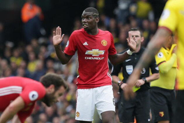 Manchester United's Paul Pogba holds up his hands and looks to the bench during the English Premier League soccer match between Watford and Manchester United at Vicarage Road in London, Sunday Sept. 18, 2016. (AP Photo/Tim Ireland)