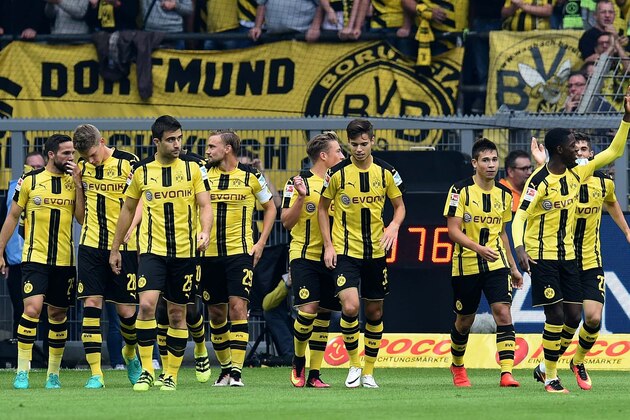 Dortmund's players celebrate after scoring the 1-0 during the German first division Bundesliga football match of Borussia Dortmund vs SV Darmstadt 98 in Dortmund, western Germany, on September 17, 2016. / AFP / PATRIK STOLLARZ / RESTRICTIONS: DURING MATCH TIME: DFL RULES TO LIMIT THE ONLINE USAGE TO 15 PICTURES PER MATCH AND FORBID IMAGE SEQUENCES TO SIMULATE VIDEO. == RESTRICTED TO EDITORIAL USE == FOR FURTHER QUERIES PLEASE CONTACT DFL DIRECTLY AT + 49 69 650050
        (Photo credit should read PATRIK STOLLARZ/AFP/Getty Images)