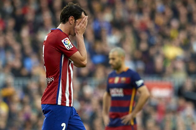 BARCELONA, SPAIN - JANUARY 30:  Godin of Atletico de Madrid leaves the field after receiving a red card during the La Liga match between FC Barcelona and Atletico de Madrid at Camp Nou on January 30, 2016 in Barcelona, Spain.  (Photo by Manuel Queimadelos Alonso/Getty Images)