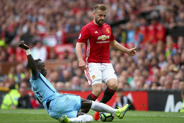 MANCHESTER, ENGLAND - SEPTEMBER 10: Luke Shaw of Manchester United is tackled Bacary Sagna of Manchester City during the Premier League match between Manchester United and Manchester City at Old Trafford on September 10, 2016 in Manchester, England.  (Photo by Alex Livesey/Getty Images)