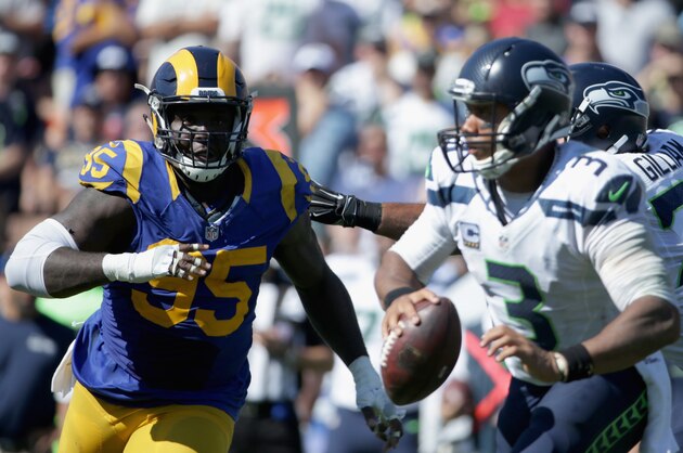 LOS ANGELES, CA - SEPTEMBER 18:  William Hayes #95 of the Los Angeles Rams chases quarterback  Russell Wilson #3 of the Seattle Seahawks during the fourth quarter of the home opening NFL game at Los Angeles Coliseum on September 18, 2016 in Los Angeles, California.  (Photo by Jeff Gross/Getty Images)