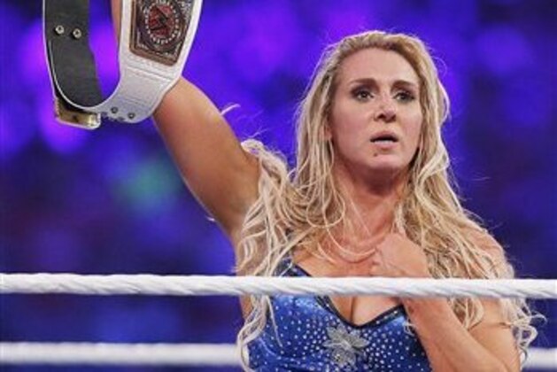IMAGE DISTRIBUTED FOR WWE - WWE women's champion Charlotte celebrates her victory at WWE WrestleMania 32 at AT&T Stadium on Sunday, April 3, 2016, in Arlington, Texas. (Brandon Wade/AP Images for WWE)