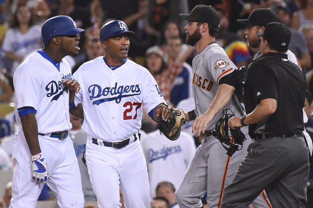 LOS ANGELES, CA - SEPTEMBER 19:  George Lombard #27 of the Los Angeles Dodgers gets in-between Yasiel Puig #66 of the Los Angeles Dodgers and Brandon Belt #9 of the San Francisco Giants and Madison Bumgarner #40 of the San Francisco Giants after words were exchanged after the final out of the seventh  inning of the game at Dodger Stadium on September 19, 2016 in Los Angeles, California. (Photo by Jayne Kamin-Oncea/Getty Images)