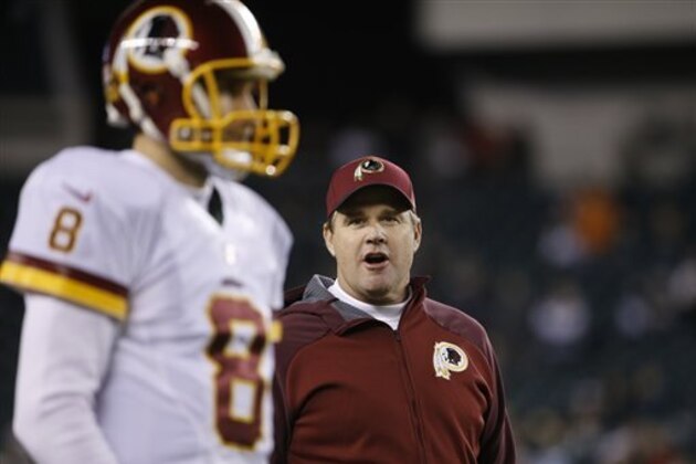 Washington Redskins head coach Jay Gruden, right, watches quarterback Kirk Cousins warm up before an NFL football game against the Philadelphia Eagles, Saturday, Dec. 26, 2015, in Philadelphia.  (AP Photo/Matt Rourke)