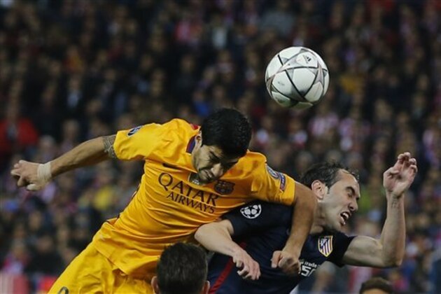 Barcelona's Luis Suarez, left, elbows Atletico's Diego Godin as they jump for a high ball during the Champions League 2nd leg quarterfinal soccer match between Atletico Madrid and Barcelona at the Vicente Calderon stadium in Madrid, Spain, Wednesday April 13, 2016. (AP Photo/Paul White)
