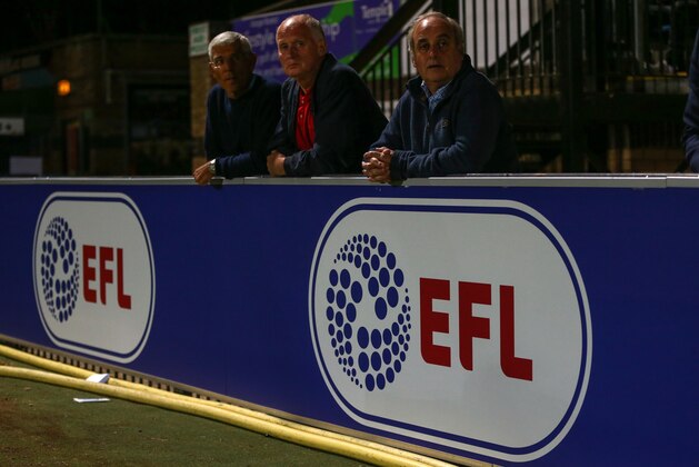 HIGH WYCOMBE, ENGLAND - AUGUST 08: Fans watch the match from behind an EFL advertisement board during the EFL Cup match between Wycombe Wanderers and Bristol City at Adams Park on August 8, 2016 in High Wycombe, England. (Photo by Catherine Ivill - AMA/Getty Images)