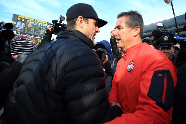 ANN ARBOR, MI - NOVEMBER 28: Head coach Urban Meyer of the Ohio State Buckeyes and head coach Jim Harbaugh of the Michigan Wolverines after the game against the Michigan Wolverines at Michigan Stadium on November 28, 2015 in Ann Arbor, Michigan. Ohio State defeated Michigan 42-13. (Photo by Andrew Weber/Getty Images)