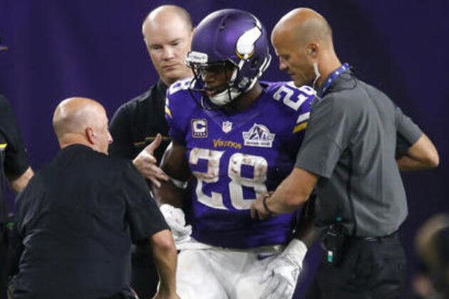Minnesota Vikings running back Adrian Peterson (28) is helped off the field after getting injured during the second half of an NFL football game against the Green Bay Packers Sunday, Sept. 18, 2016, in Minneapolis. (AP Photo/Jim Mone)