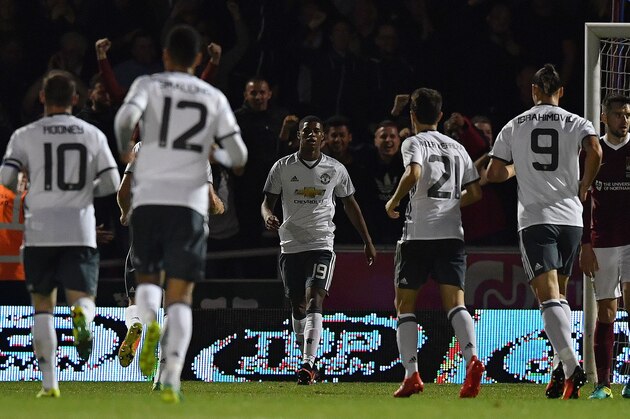 Manchester United's English striker Marcus Rashford (C) celebrates scoring his team's third goal during the English League Cup third round football match between Northampton Town and Manchester United at the Sixfields Stadium in Northampton, central England, on September 21, 2016. / AFP / Ben STANSALL / RESTRICTED TO EDITORIAL USE. No use with unauthorized audio, video, data, fixture lists, club/league logos or 'live' services. Online in-match use limited to 75 images, no video emulation. No use in betting, games or single club/league/player publications.  /         (Photo credit should read BEN STANSALL/AFP/Getty Images)