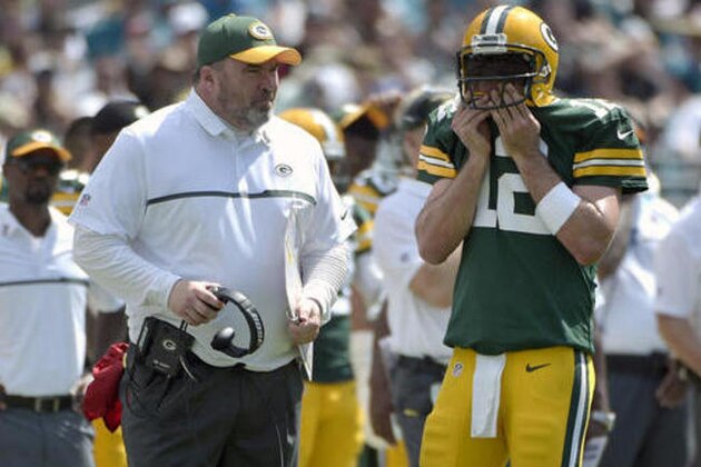 FILE - In this Sept. 11, 2016, file photo, Green Bay Packers head coach Mike McCarthy and quarterback Aaron Rodgers (12) chat on the sideline during the second half of an NFL football game against the Jacksonville Jaguars in Jacksonville, Fla. McCarthy is confident that Rodgers and Green Bay’s struggling offense will get better. Two games into the season, the results have been uncharacteristically ugly. (AP Photo/Phelan M. Ebenhack, File)
