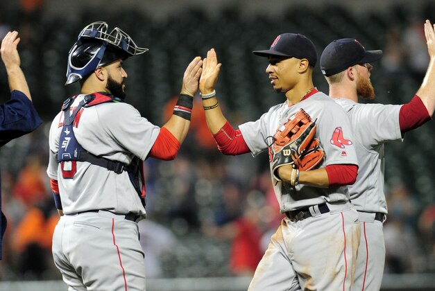 Sep 20, 2016; Baltimore, MD, USA; Boston Red Sox outfielder Mookie Betts (50) high fives catcher Sandy Leon (3) after beating the Baltimore Orioles 5-2 at Oriole Park at Camden Yards. Mandatory Credit: Evan Habeeb-USA TODAY Sports