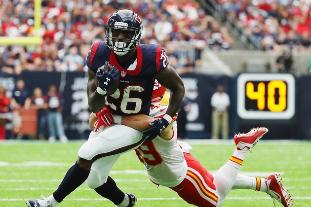 HOUSTON, TX - SEPTEMBER 18:   Lamar Miller #26 of the Houston Texans runs away from the tackle of  Daniel Sorensen #49 of the Kansas City Chiefs in the second quarter of their game at NRG Stadium on September 18, 2016 in Houston, Texas.  (Photo by Scott Halleran/Getty Images)