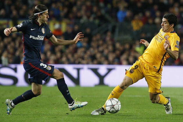 Atletico Madrid's Brazilian defender Filipe Luis (L) vies with Barcelona's Uruguayan forward Luis Suarez during the UEFA Champions League quarter finals first leg football match FC Barcelona vs Atletico de Madrid at the Camp Nou stadium in Barcelona on April 5, 2016. / AFP / PAU BARRENA        (Photo credit should read PAU BARRENA/AFP/Getty Images)