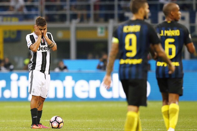 Juventus' forward Paulo Dybala from Argentina (L) reacts during the Italian Serie A football match Inter Milan vs Juventus on September 18, 2016 at the 'San Siro Stadium' in Milan. / AFP / MARCO BERTORELLO        (Photo credit should read MARCO BERTORELLO/AFP/Getty Images)