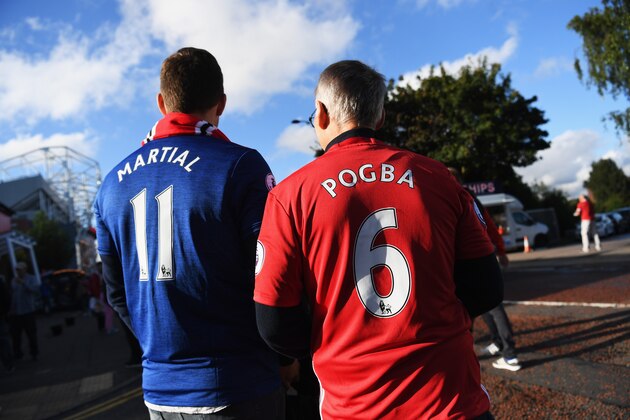 MANCHESTER, ENGLAND - AUGUST 19:  A Manchester United fan wears the number 6 shirt to be worn by Paul Pogba prior to the Premier League match between Manchester United and Southampton at Old Trafford on August 19, 2016 in Manchester, England.  (Photo by Michael Regan/Getty Images)