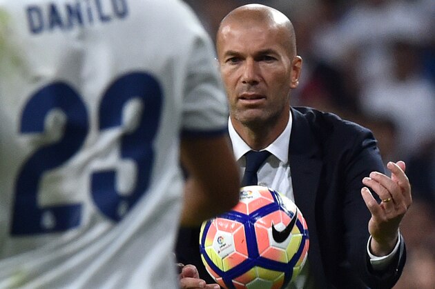 Real Madrid's French coach Zinedine Zidane passes the ball during the Spanish league football match Real Madrid CF vs Villarreal CF at the Santiago Bernabeu stadium in Madrid on September 21, 2016. / AFP / GERARD JULIEN        (Photo credit should read GERARD JULIEN/AFP/Getty Images)