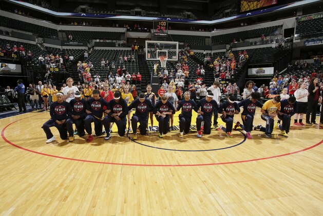 INDIANAPOLIS, IN - SEPTEMBER 21:  The Indiana Fever kneel during the National Anthem before the game against the Phoenix Mercury during Round One of the 2016 WNBA Playoffs on September 21, 2016 at Bankers Life Fieldhouse in Indianapolis, Indiana. NOTE TO USER: User expressly acknowledges and agrees that, by downloading and or using this Photograph, user is consenting to the terms and conditions of the Getty Images License Agreement. Mandatory Copyright Notice: Copyright 2016 NBAE (Photo by Ron Hoskins/NBAE via Getty Images)