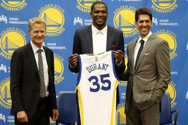 Golden State Warriors' newest player Kevin Durant, center, joins head coach Steve Kerr, left and general manager Bob Myers during a news conference at the NBA basketball team's practice facility, Thursday, July 7, 2016, in Oakland, Calif. (AP Photo/Beck Diefenbach)
