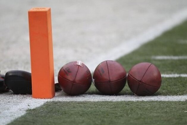 Footballs are lined up by a pylon before an NFL football game between the Kansas City Chiefs and the Oakland Raiders in Kansas City, Mo., Sunday, Dec. 14, 2014. (AP Photo/Ed Zurga)