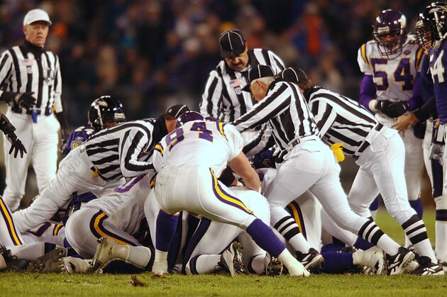 07 Jan 2002: Officials try to get to the bottom of the pile to rule on a fumble recovery as the Baltimore Ravens host the Minnesota Vikings in the second qurter of week 17 NFL action at PSINet Stadium in Baltimore, Maryland. DIGITAL IMAGE. Mandatory Credit: Doug Pensinger/Getty Images