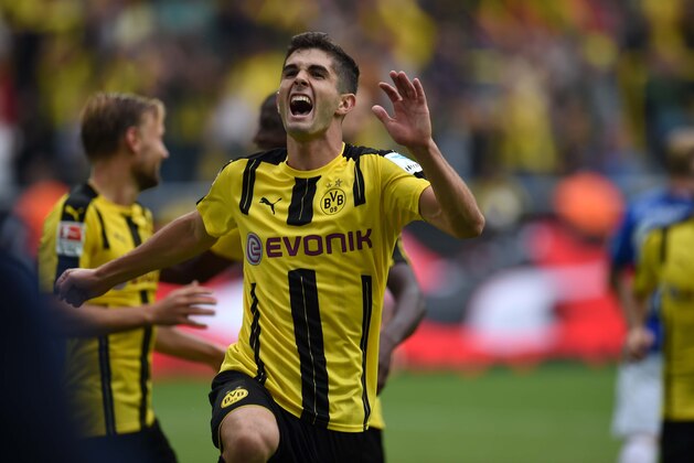 Dortmund's US midfielder Christian Pulisic celebrates during the German first division Bundesliga football match of Borussia Dortmund vs SV Darmstadt 98 in Dortmund, western Germany, on September 17, 2016. / AFP / PATRIK STOLLARZ / RESTRICTIONS: DURING MATCH TIME: DFL RULES TO LIMIT THE ONLINE USAGE TO 15 PICTURES PER MATCH AND FORBID IMAGE SEQUENCES TO SIMULATE VIDEO. == RESTRICTED TO EDITORIAL USE == FOR FURTHER QUERIES PLEASE CONTACT DFL DIRECTLY AT + 49 69 650050
        (Photo credit should read PATRIK STOLLARZ/AFP/Getty Images)