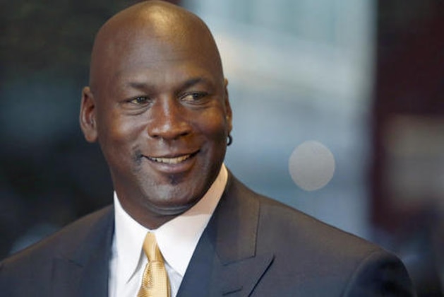 FILE - In this Aug. 21, 2015, file photo, former NBA star and current owner of the Charlotte Hornets, Michael Jordan, smiles at reporters in Chicago. Jordan has made another major donation, pledging $5 million to the Smithsonian's new African-American history museum on the National Mall, officials at the National Museum of African American History and Culture announced Monday, Aug. 8, 2016. (AP Photo/Charles Rex Arbogast, File)